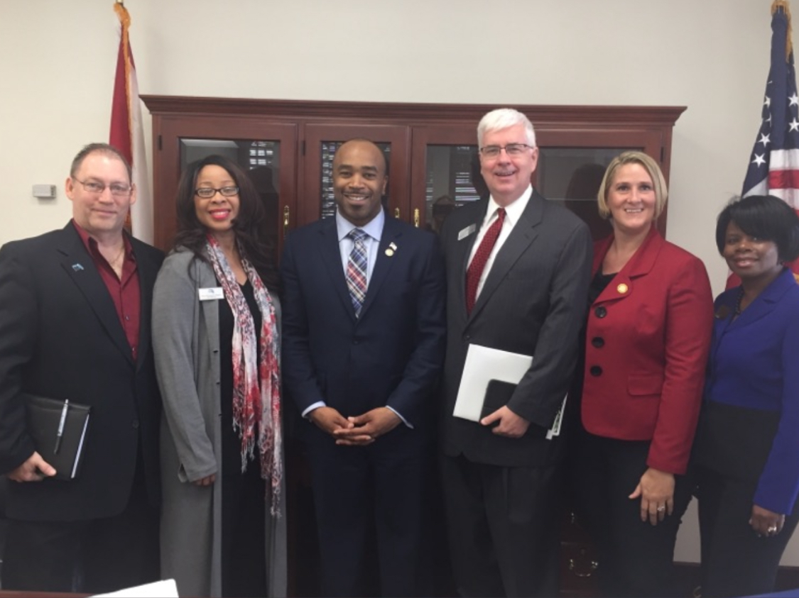 Dr. TL Coleman with leaders in a formal meeting